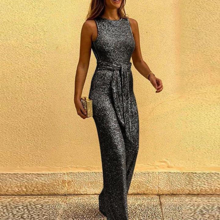 Fashionable dazzling sparkly women's jumpsuit. A glamorous wide-leg, V-neck festive outfit for celebration.