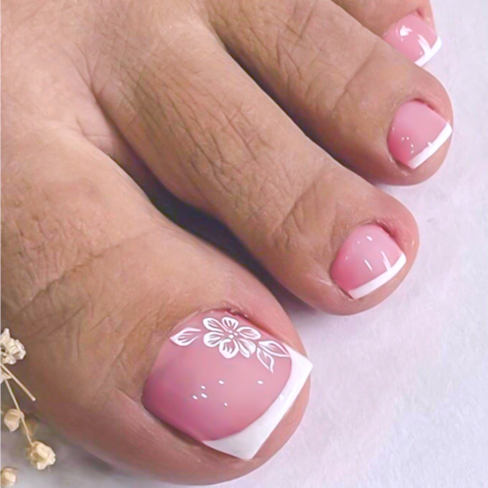 Artificial French tip toenails for women. Stylish decorative press-on nails for a perfect pedicure.