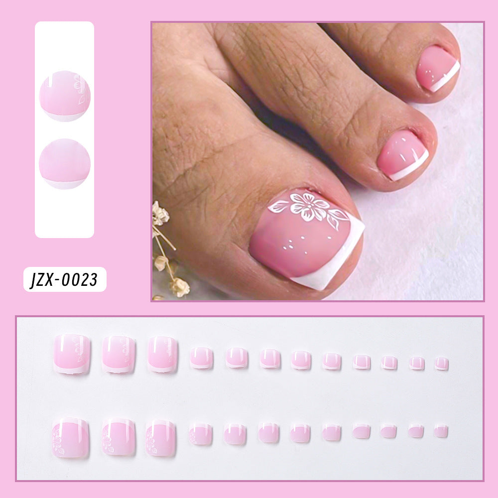 Women's decorative French tip press-on toenail set. Premium artificial nails for a stylish DIY pedicure.