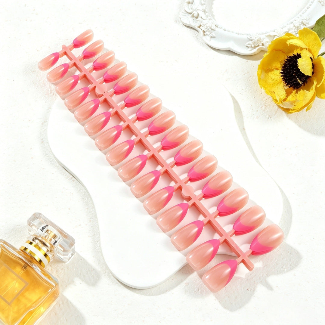 Hand showcasing elegant decorative press-on nail tips. Achieve a perfect instant manicure with these fake nails.