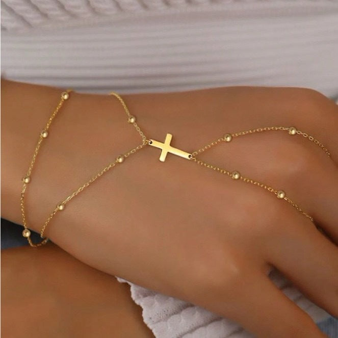 Women's delicate gold adjustable cross charm bracelet, perfect for everyday wear & spiritual fashion.