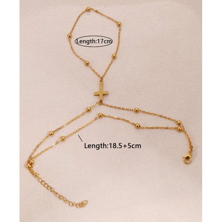 Elegant women's adjustable gold cross bracelet worn on a wrist, a delicate piece for spiritual everyday fashion.