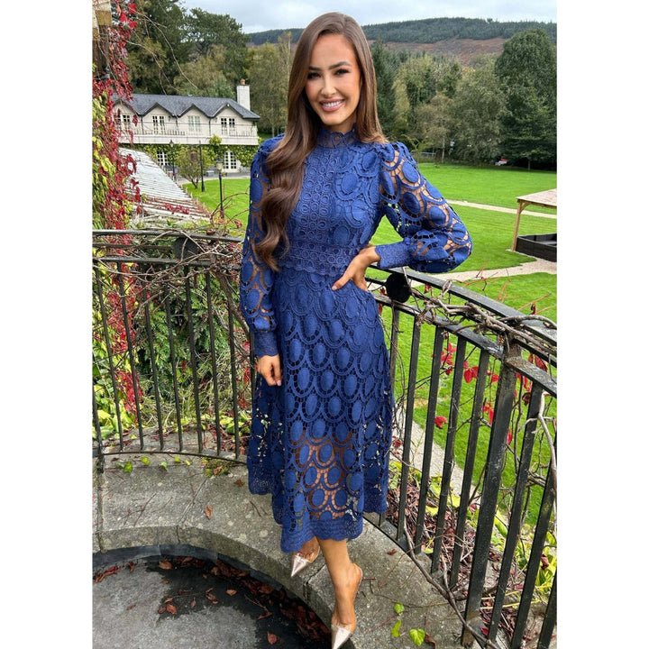 Stylish women's lace midi dress with long sheer sleeves, ideal for sophisticated evening and cocktail wear.