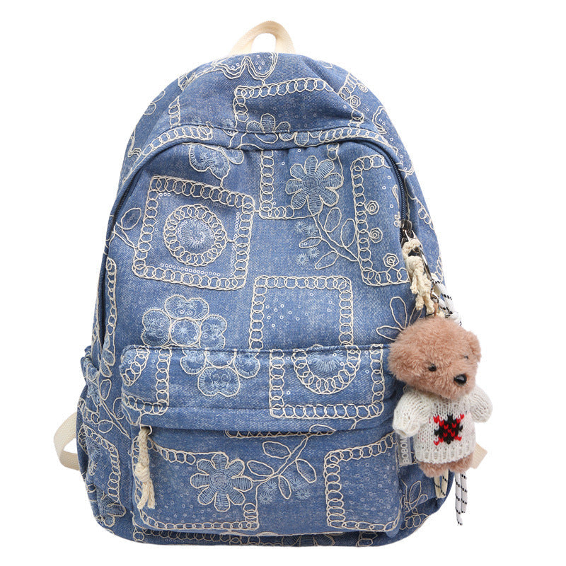 Women's denim backpack with colorful floral embroidery, perfect as a stylish school or casual fashion bag.
