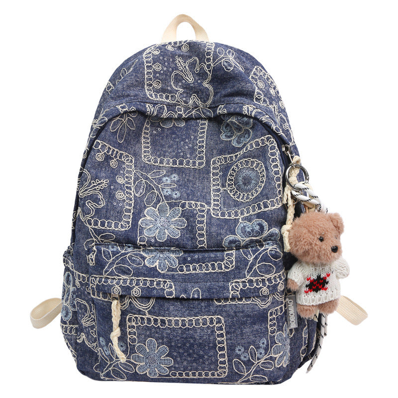 Fashionable women's floral embroidered denim backpack, ideal for daily use, school, travel, or laptop.