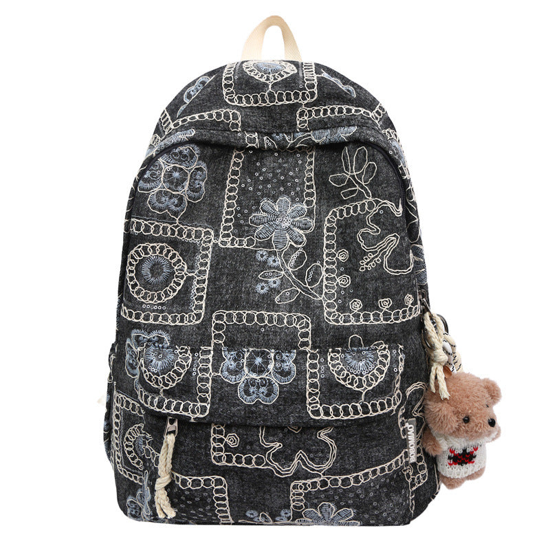 Chic women's denim backpack featuring vibrant floral embroidery, a versatile and trendy casual or travel bag.
