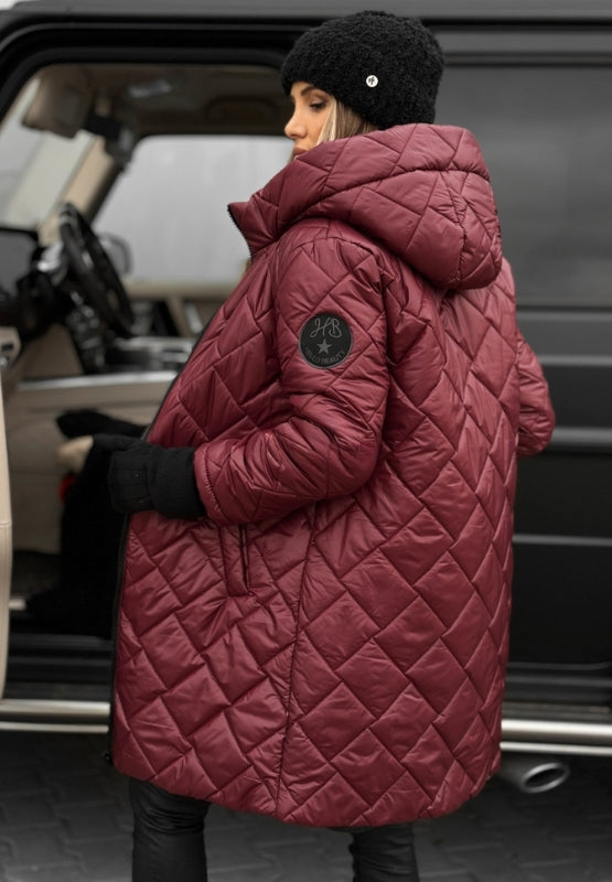 Model in a women's diamond quilted hooded jacket, ideal for layering and casual everyday wear.
