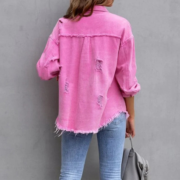 Versatile women's distressed jean jacket. Frayed hem, button-front, perfect layering piece.