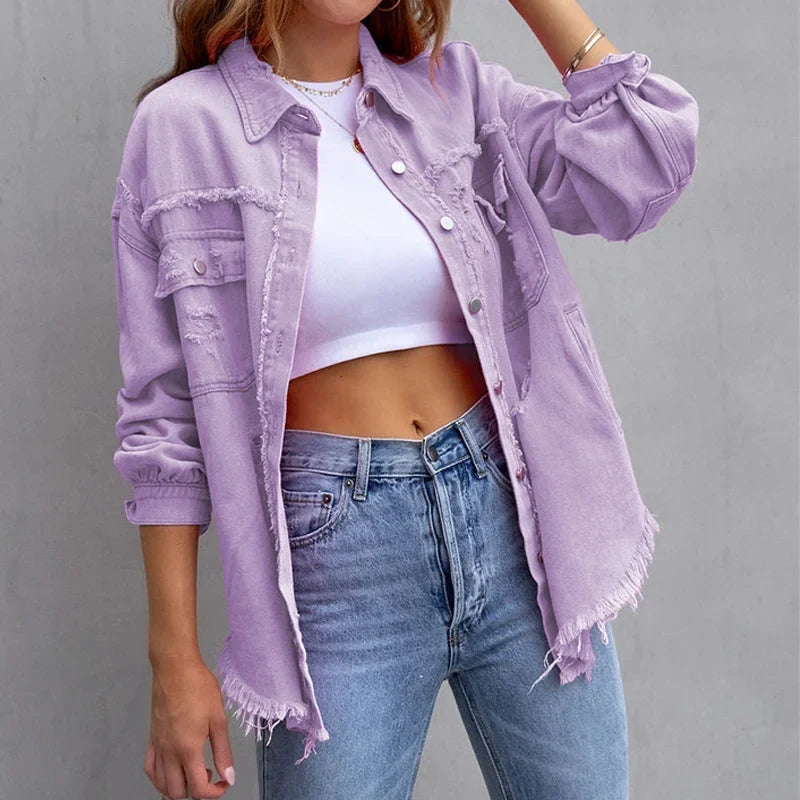 Modern vintage-style women's distressed jacket. Button-front denim with a chic frayed hem, versatile.