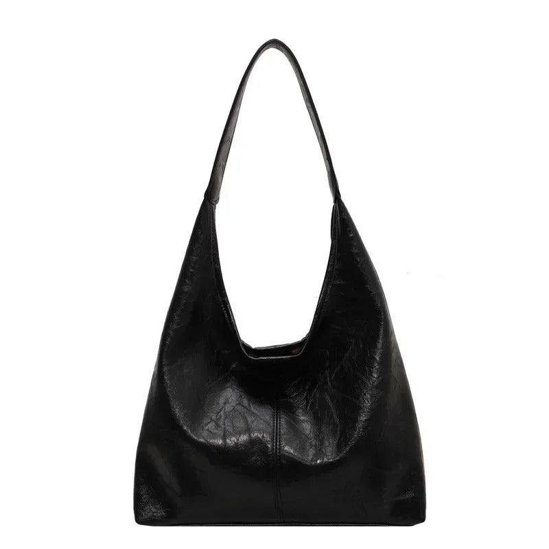 Durable distressed leather handbag, a women's tote with secure magnetic closure.