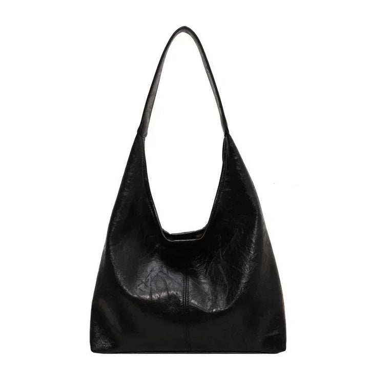 Durable distressed leather handbag, a women's tote with secure magnetic closure.