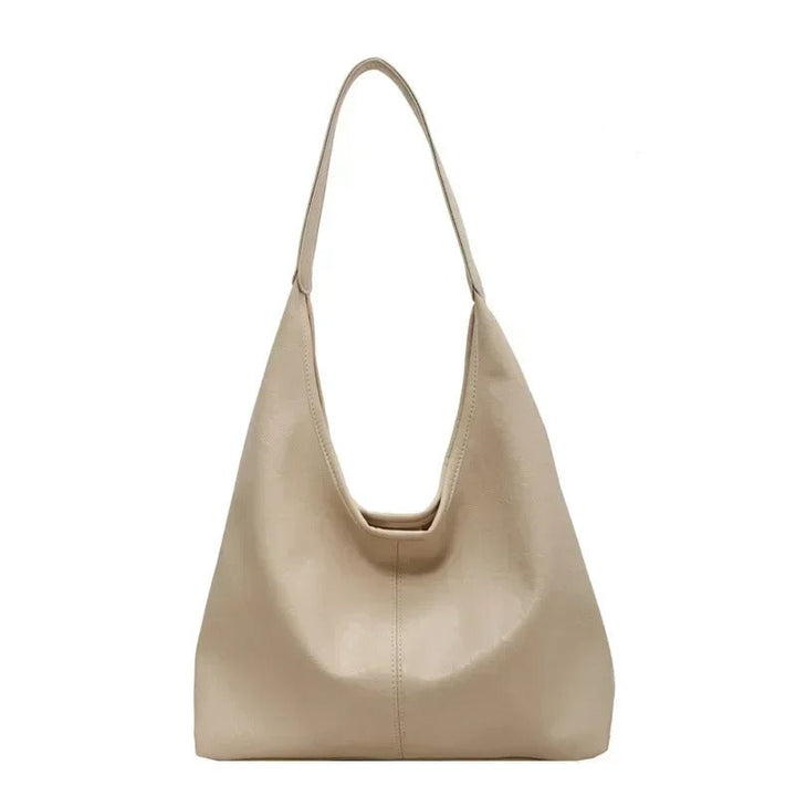 Elegant distressed leather shoulder bag, a minimalist women's tote with magnetic fastening.