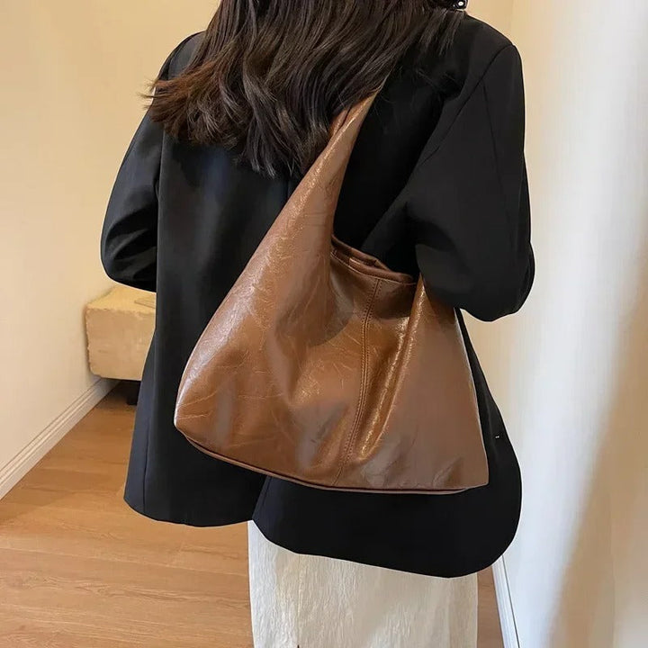 Women's chic distressed leather tote, a durable everyday handbag with magnetic closure.