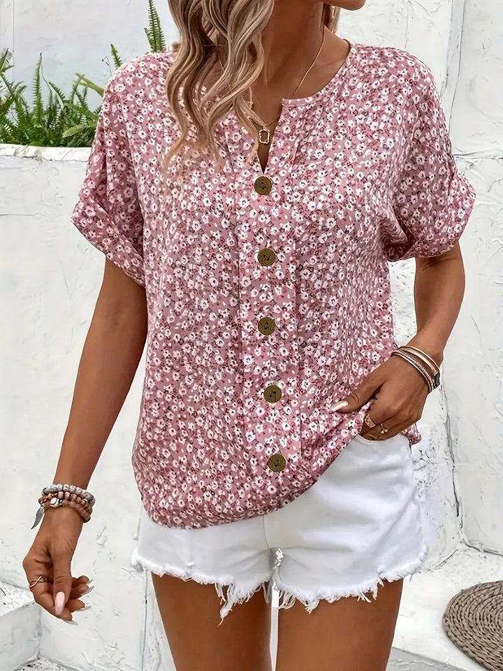 Casual women's short sleeve ditsy floral blouse with button-front closure and a comfortable relaxed fit. Ideal for spring.
