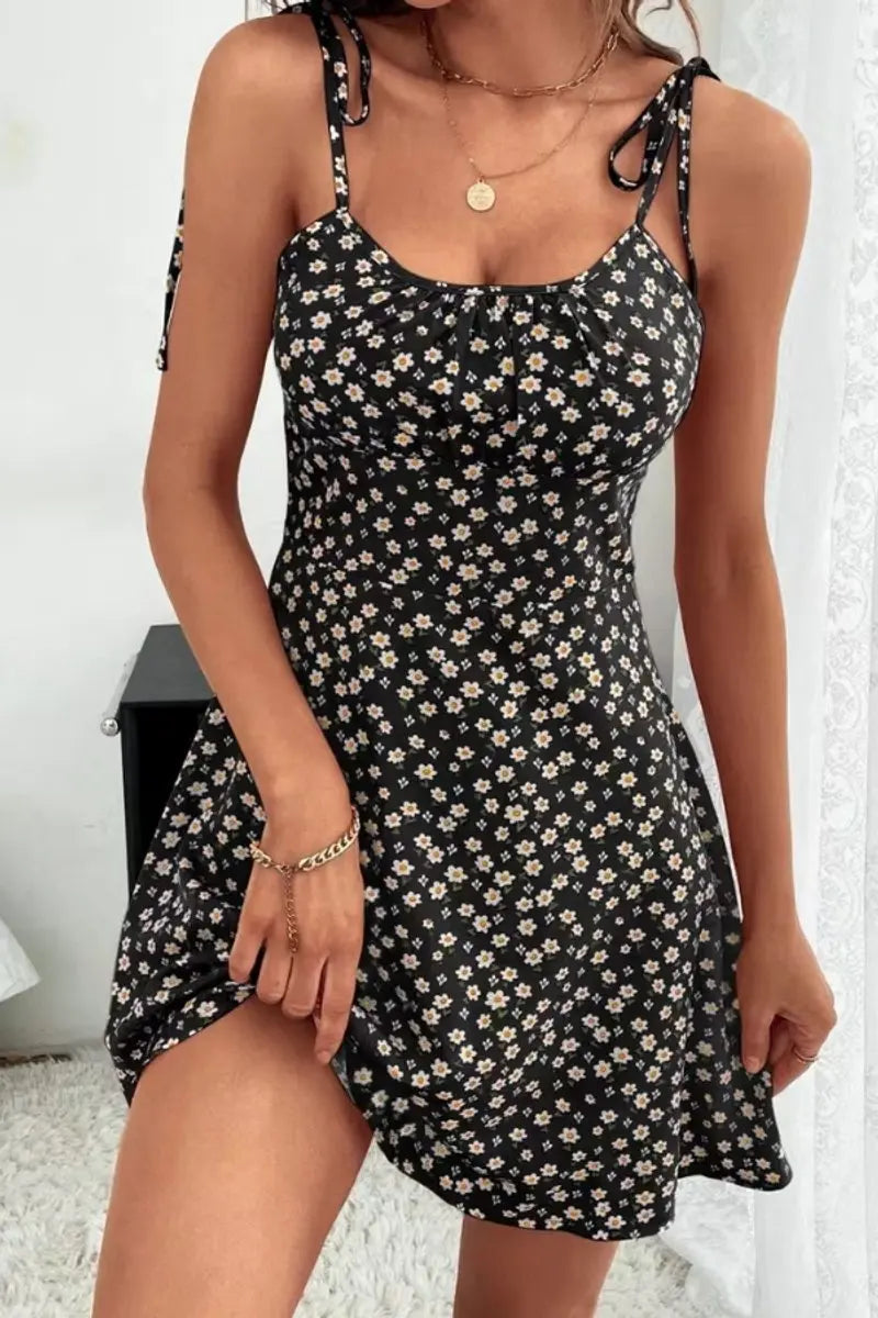 Stylish women's sleeveless ditsy floral mini dress featuring spaghetti straps & ruched body for summer.