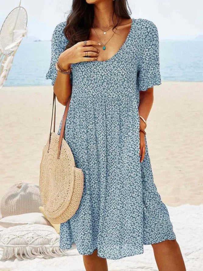 Trendy women's ditsy floral V-neck mini dress, designed with elegant flutter sleeves for spring and summer style.
