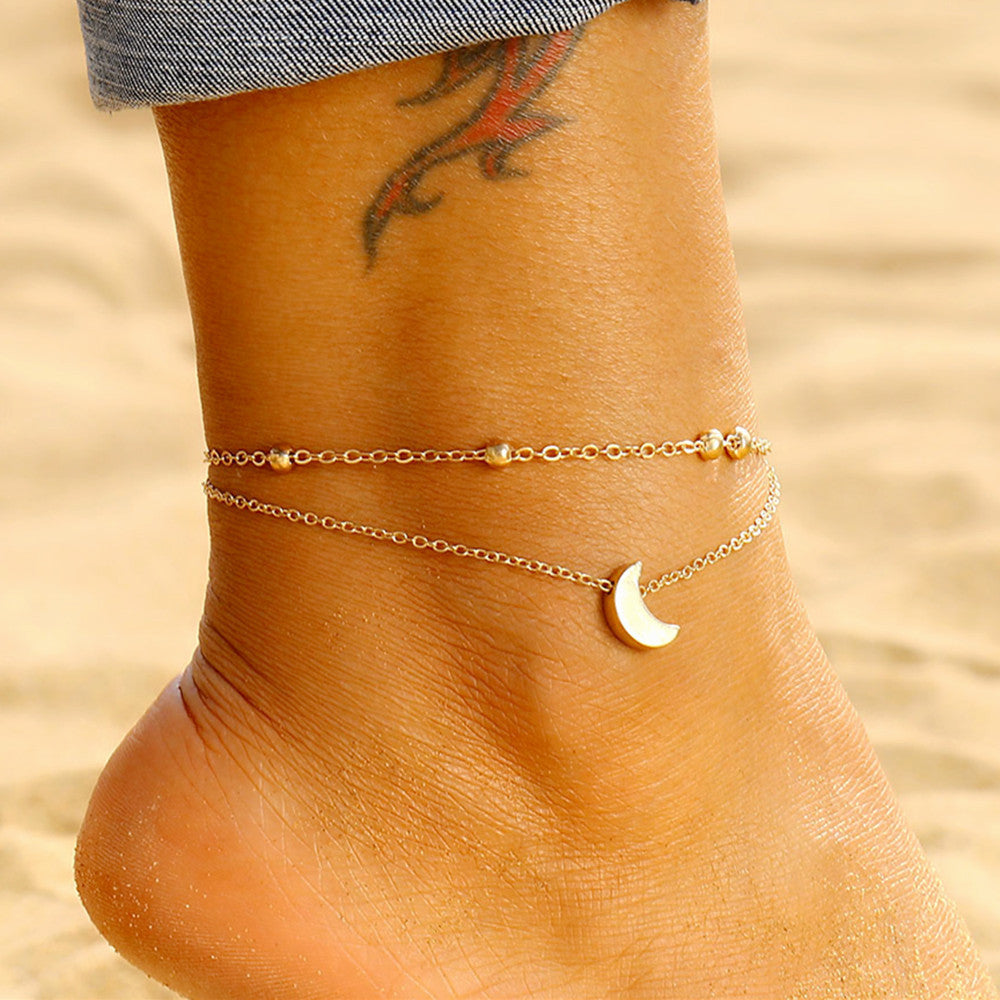 Women's double-layered moon charm anklet, elegant silver/gold celestial jewelry.