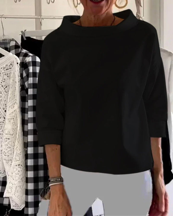 Black women's elegant cowl neck top with three-quarter sleeves. Relaxed fit, perfect for versatile day to night wear.
