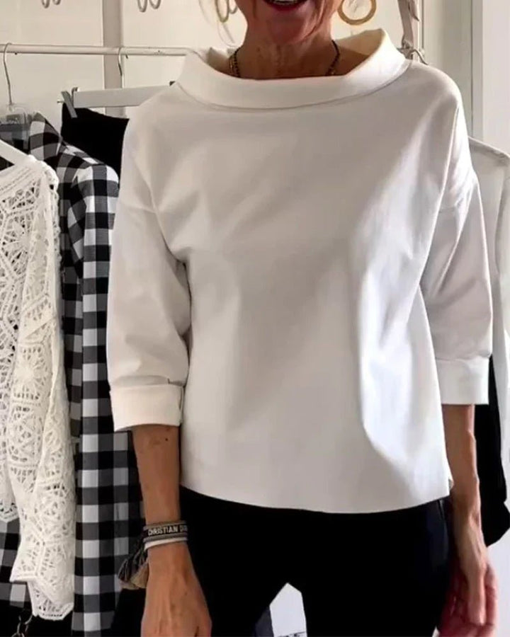 White women's relaxed fit cowl neck top. Draped three-quarter sleeve design, perfect for elegant casual outfits.