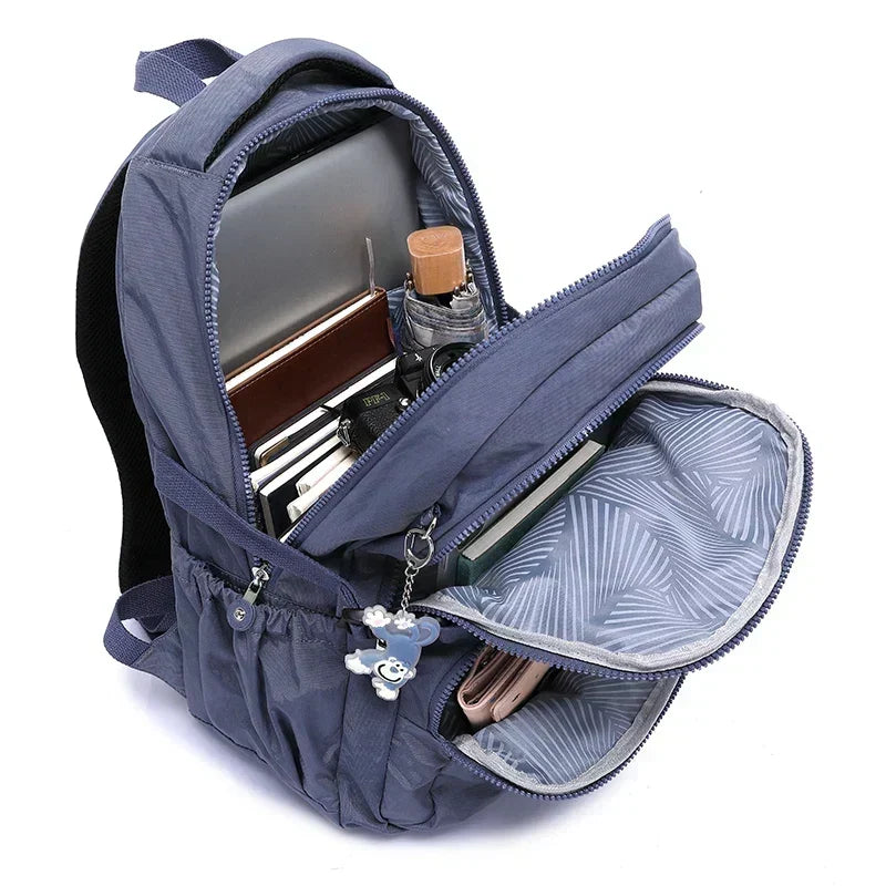 Detail of high-quality zippers on a durable women's commuter backpack, built to last.