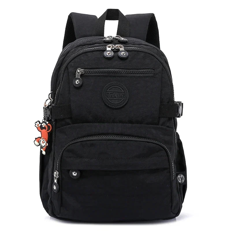 Stylish women's travel backpack made of durable water-resistant nylon, worn by a commuter.