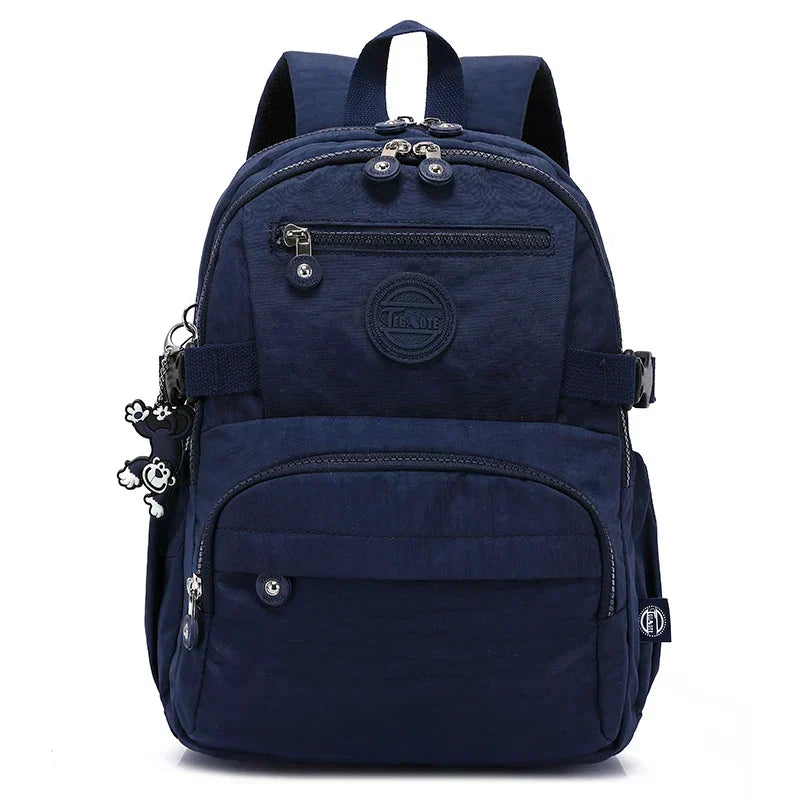 Interior of a women's nylon commuter backpack, showing spacious organized compartments.