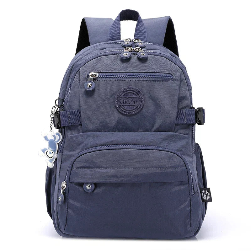 Back of a durable nylon women's backpack with padded straps, ensuring comfort for travel & work.