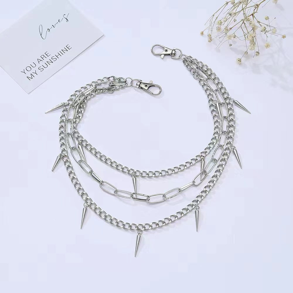 Statement women's chain belt with sharp spikes, a sleek metal design for an edgy and fashionable look.
