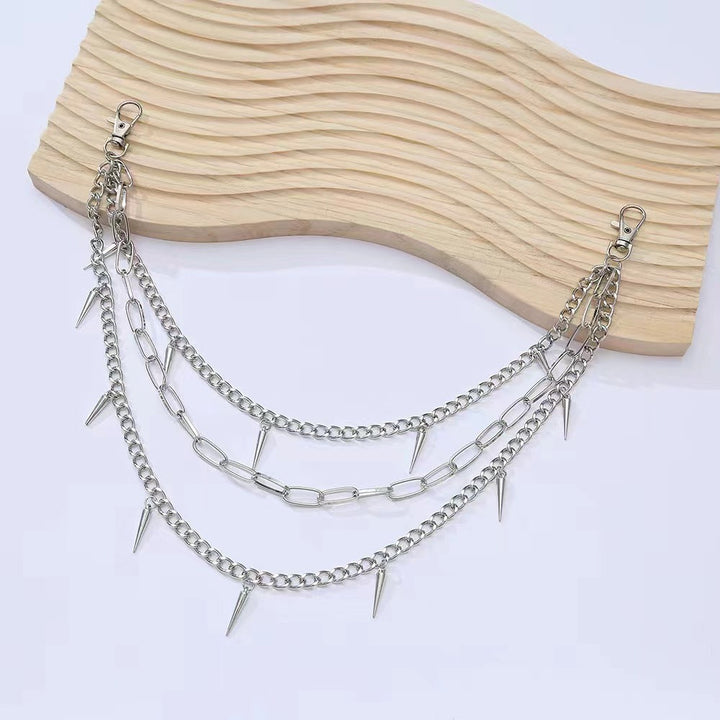 Adjustable women's spiked chain belt, a versatile edgy accessory for punk or trendy fashion outfits.