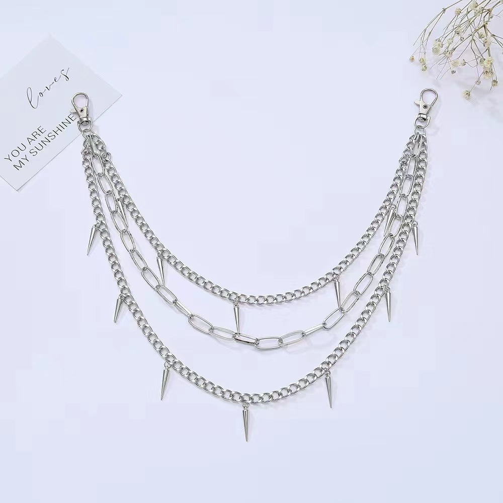 Women's metal chain belt with prominent spiked embellishments, an edgy and adjustable fashion accessory.