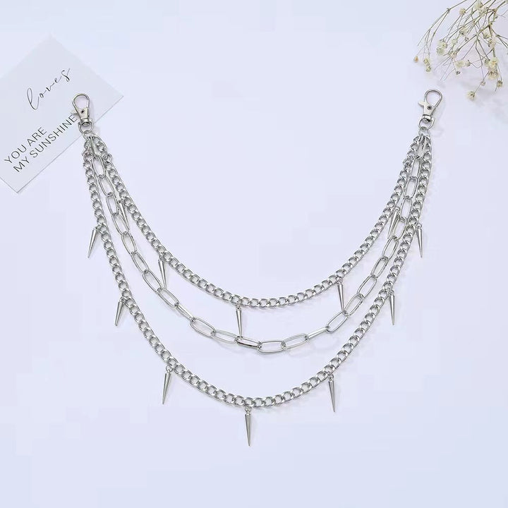 Women's metal chain belt with prominent spiked embellishments, an edgy and adjustable fashion accessory.