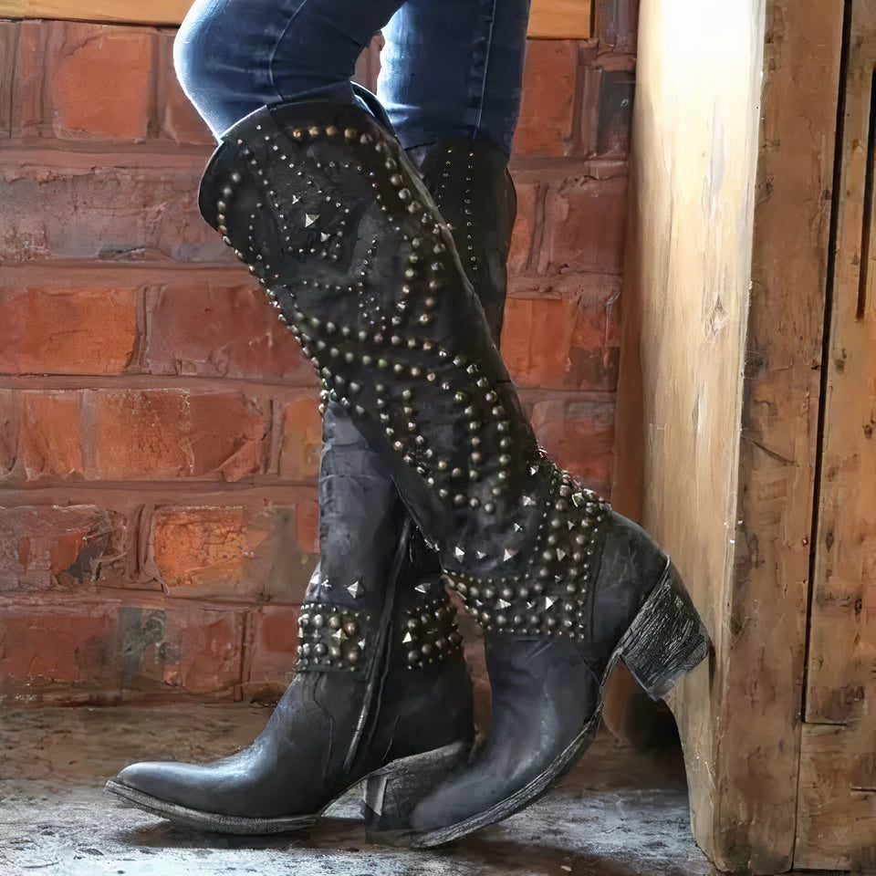Women's edgy high boots with rivet detail, thick heel, and side zipper. Perfect punk fashion statement footwear.