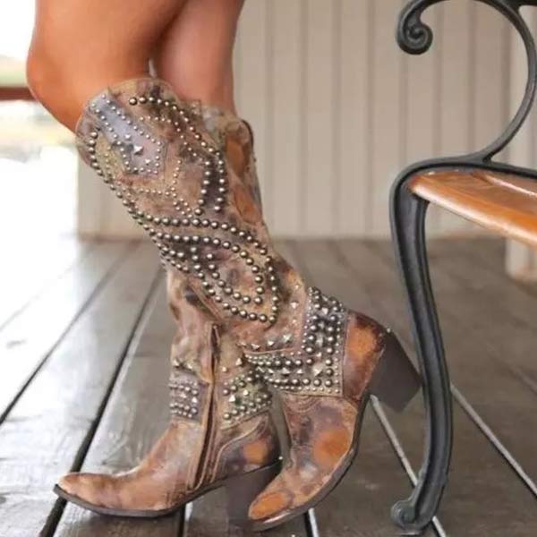 Knee-high women's edgy boots featuring striking rivet detail and a sturdy thick heel for a bold look.