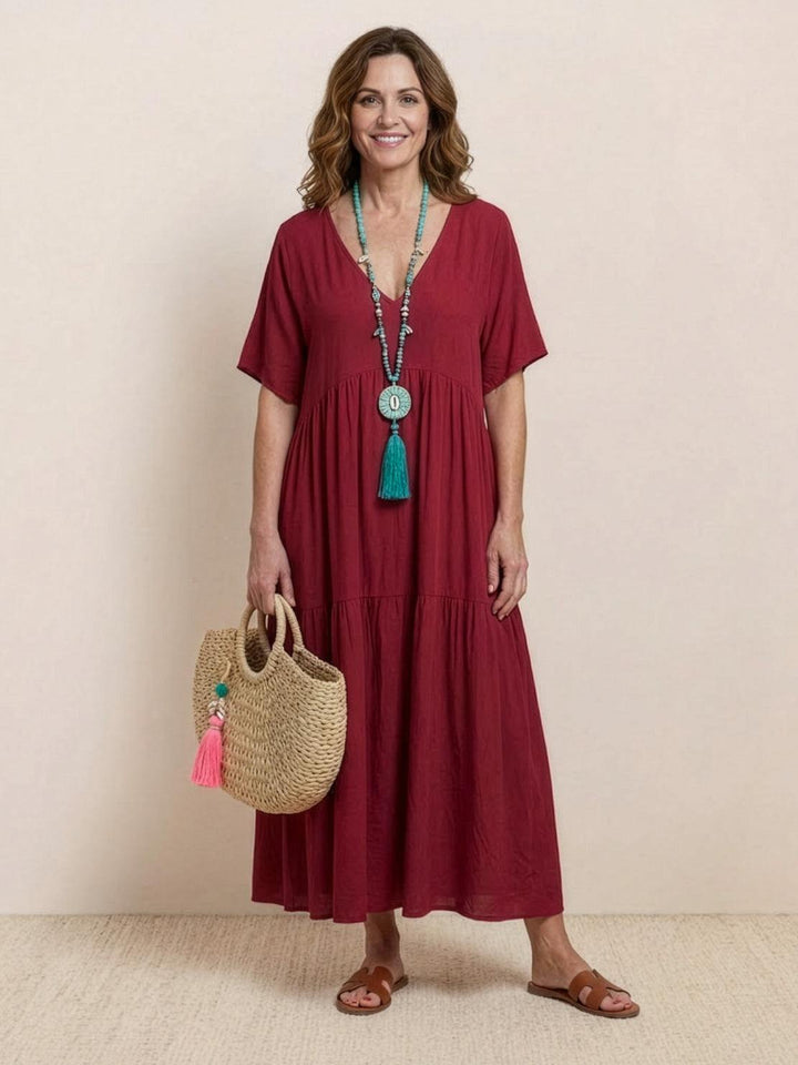 Women's vacation wear: boho V-neck tiered maxi dress. Relaxed summer style.