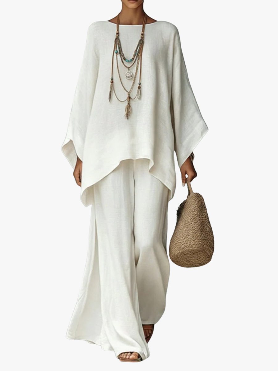 Women's effortless linen two-piece maxi set with poncho top & straight leg trousers, ideal for summer resort wear.