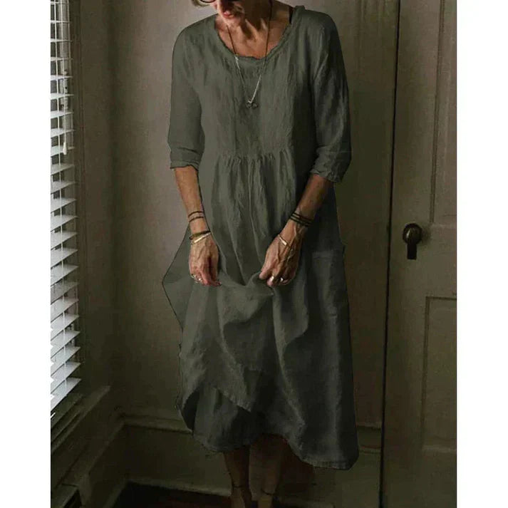 Comfortable women's midi dress, loose fit, with practical pockets, 3/4 sleeves & an elegant asymmetric design.