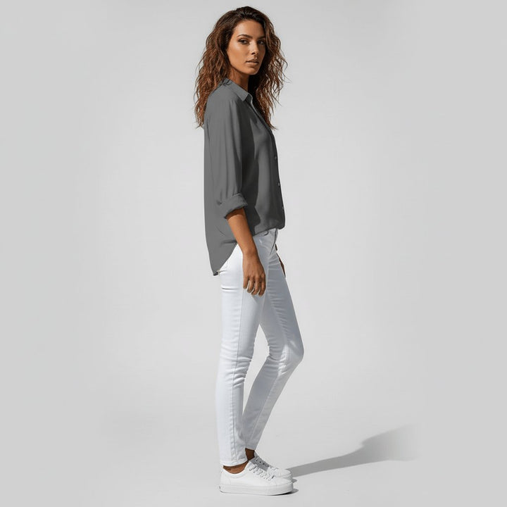 Long sleeve relaxed-fit button-up blouse for women, showcasing effortless fashion.