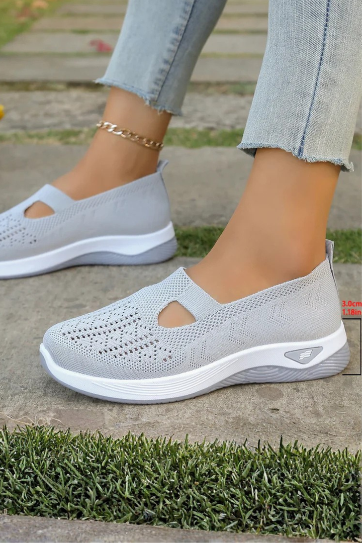 Woman walking comfortably in breathable slip-on trainers, perfect for active everyday wear.
