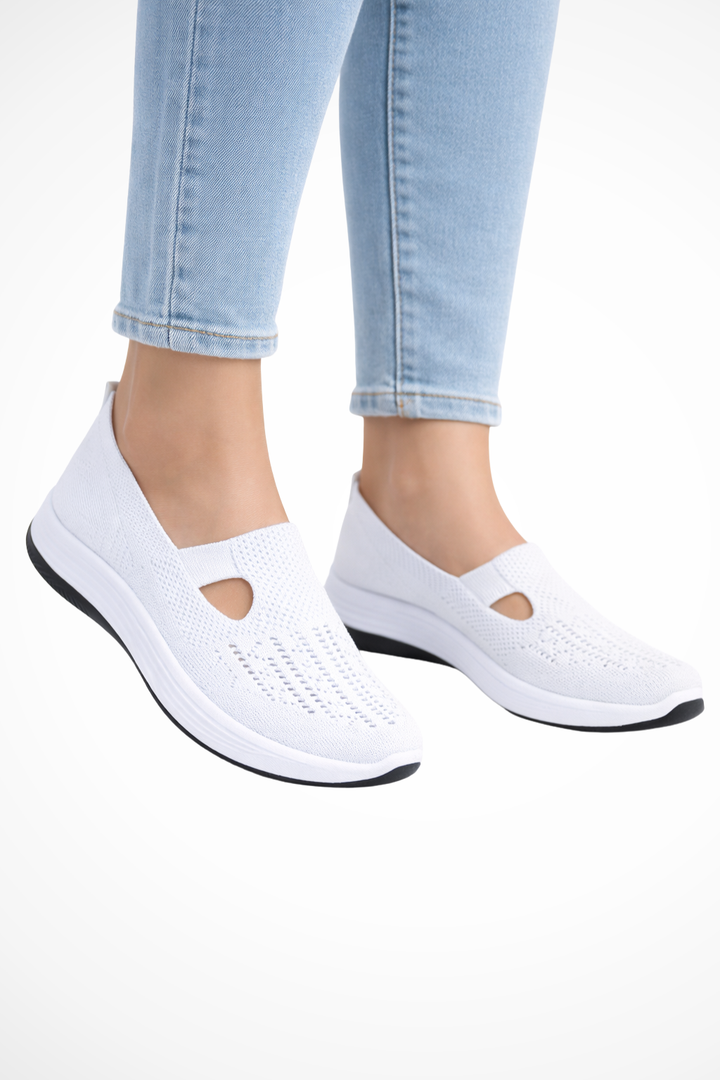 Detail of elasticized opening on women's slip-on trainers for easy on/off and secure fit.