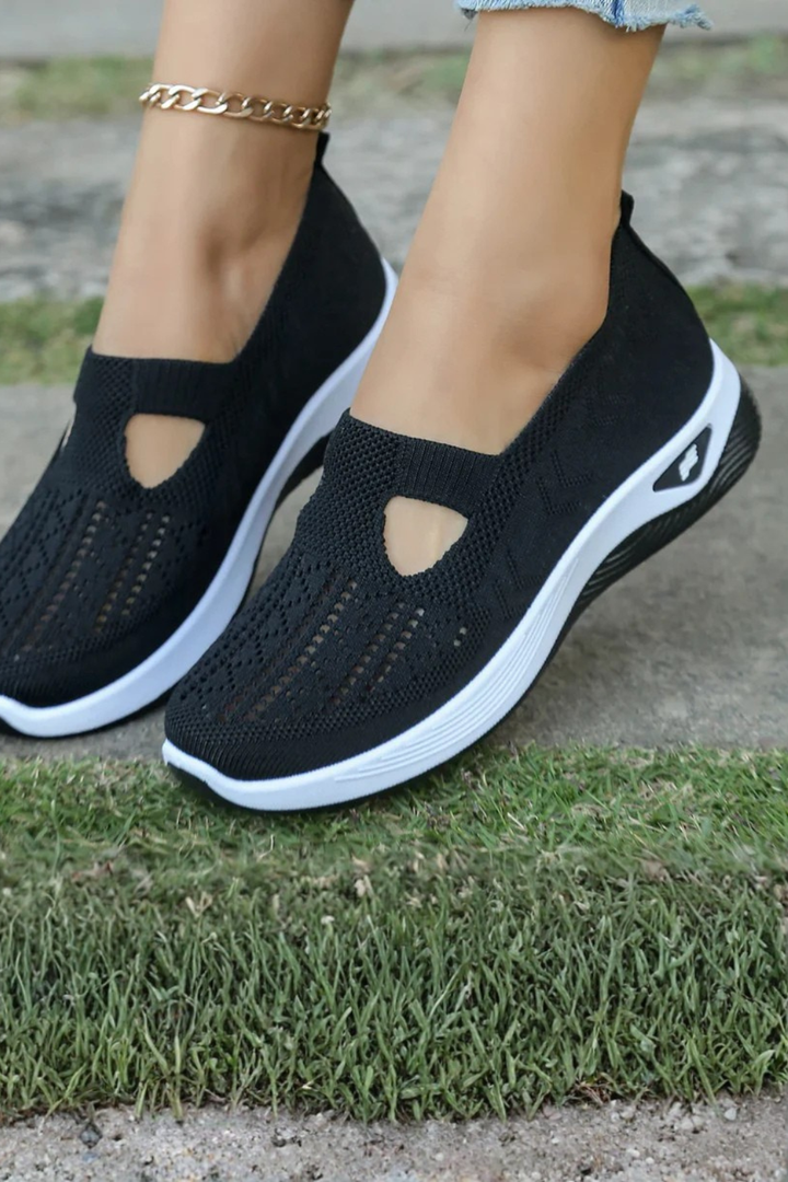 Woman wearing stylish slip-on trainers with a casual outfit, demonstrating everyday fashion.