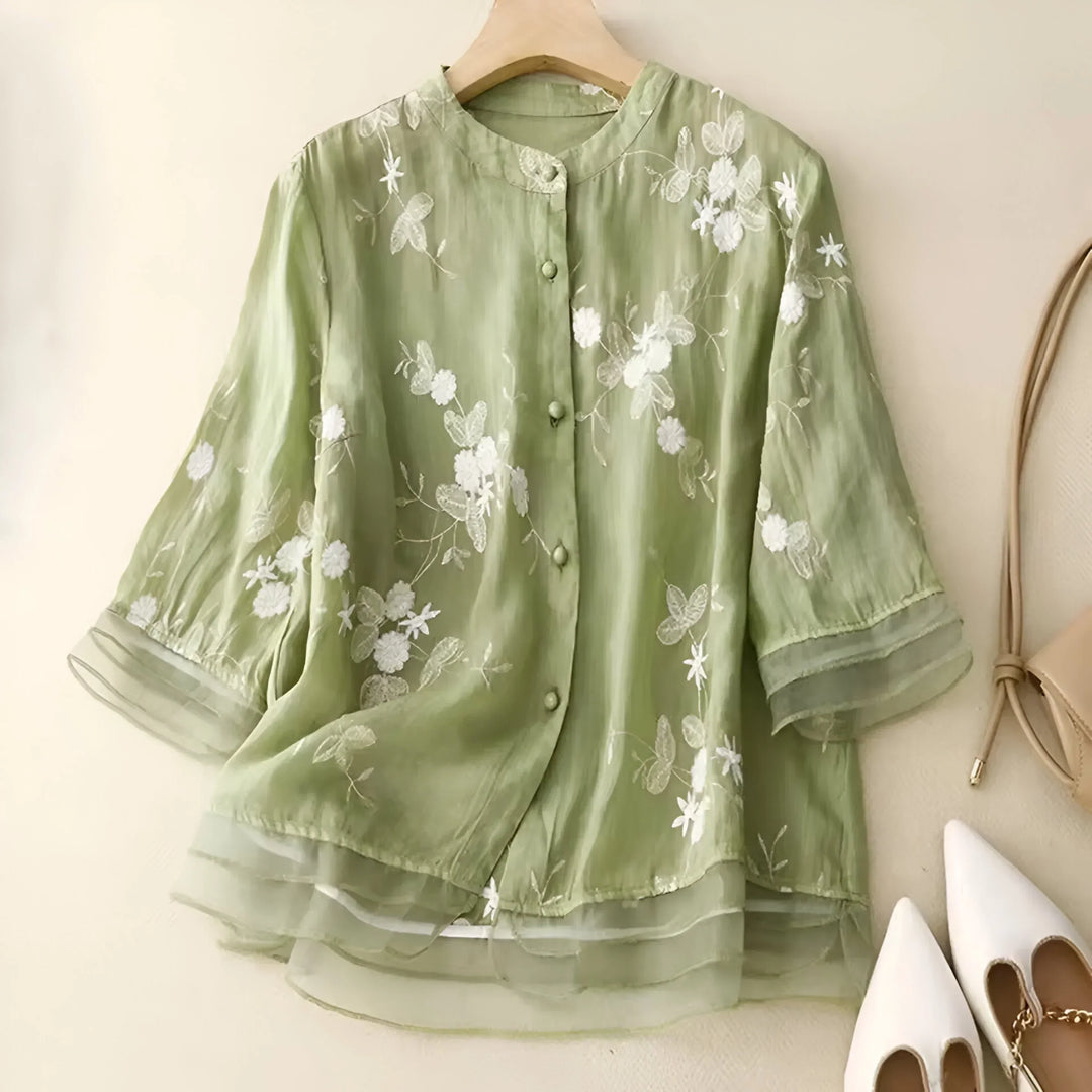 Chic women's short-sleeve top, tummy-skimming with floral embroidery, ideal for summer fashion.