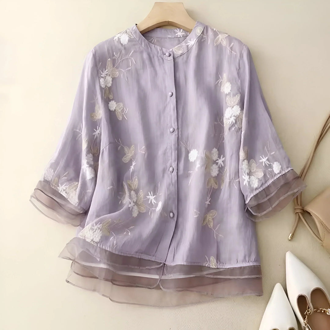 Short sleeve, round neck women's top with floral accents, an elegant and versatile summer piece.