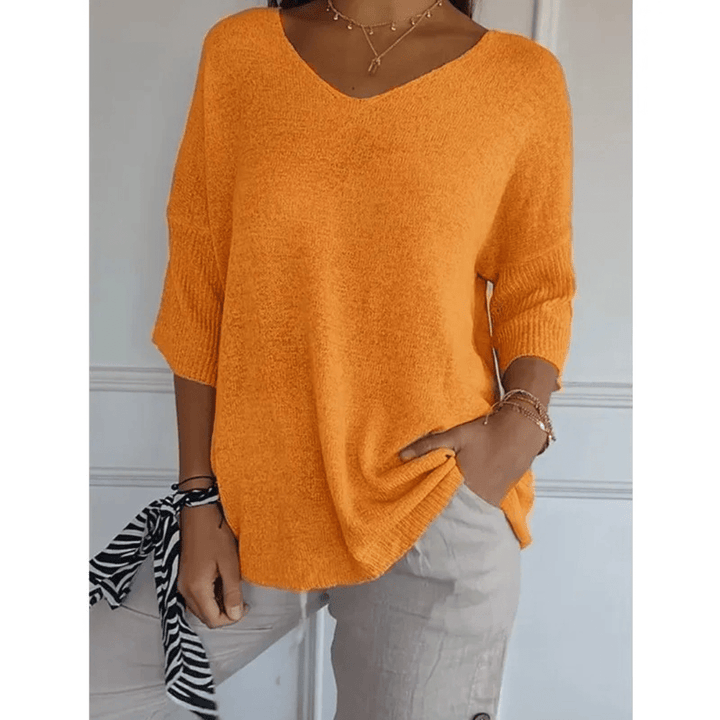 Relaxed fit women's top, V-neck, 3/4 sleeves. Chic and comfortable for versatile fashion.