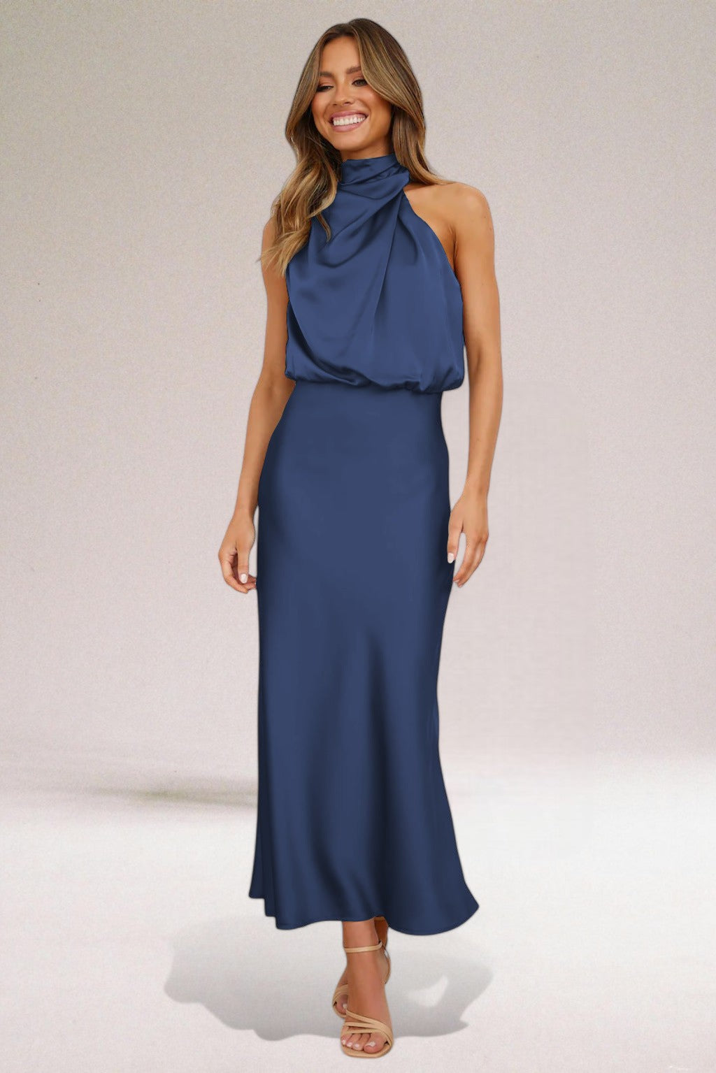 Beige Elara women's elegant flowing evening dress, a sophisticated long halter neck gown for special events.