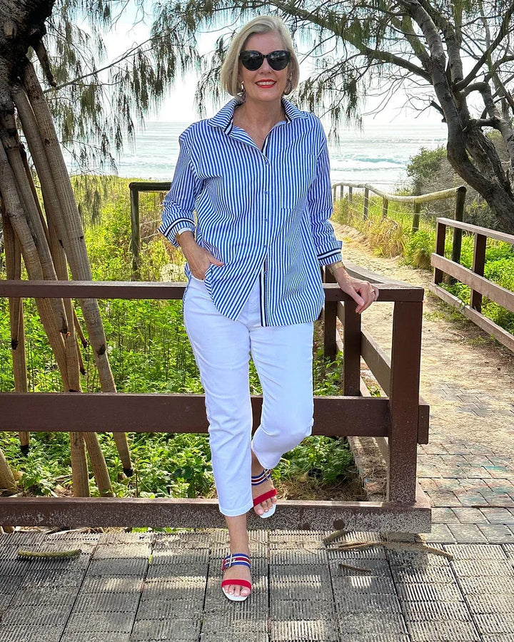 Versatile women's striped button-down blouse in baby pink, an elegant long sleeve top for everyday fashion.