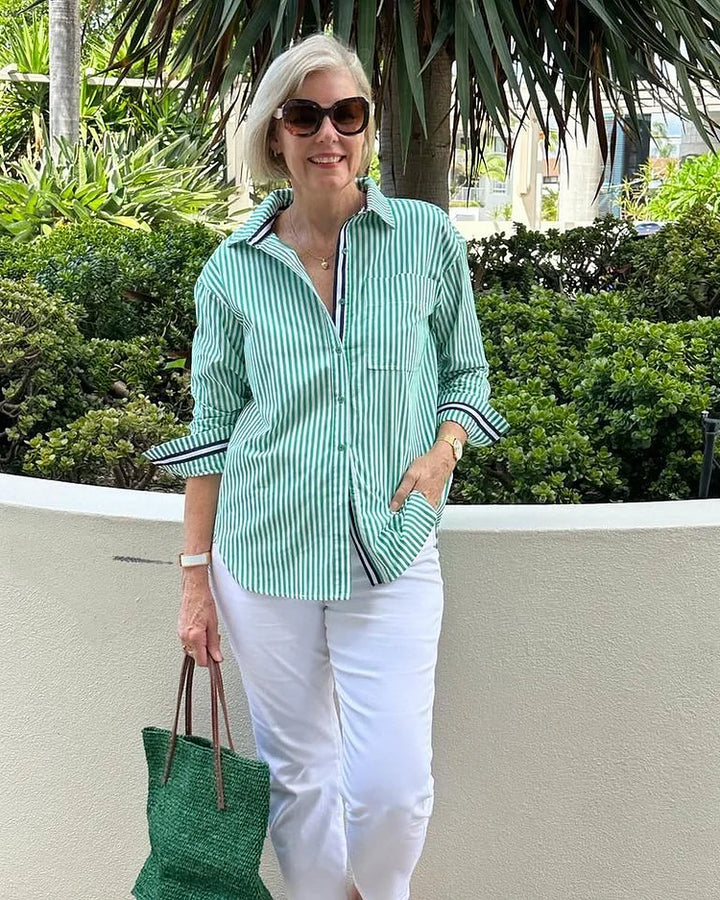 Stylish women's baby pink striped button-down shirt, an elegant long sleeve blouse suitable for any occasion.