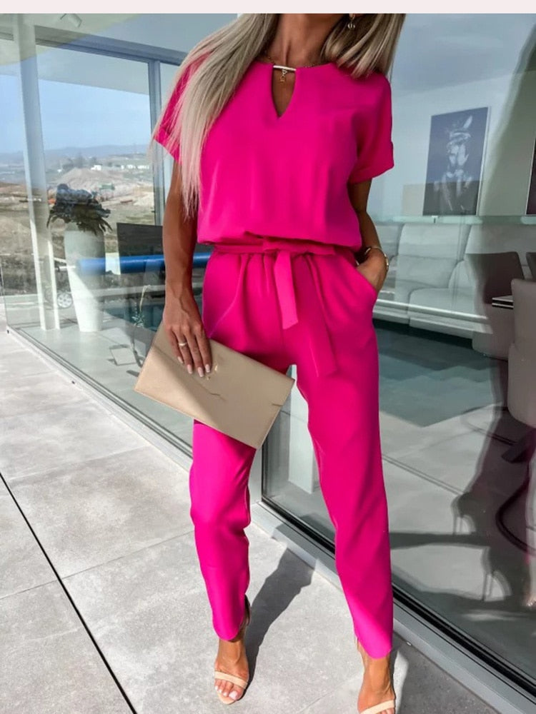 Fashionable women's wide-leg jumpsuit, cinched with a belt for a flattering and chic silhouette.