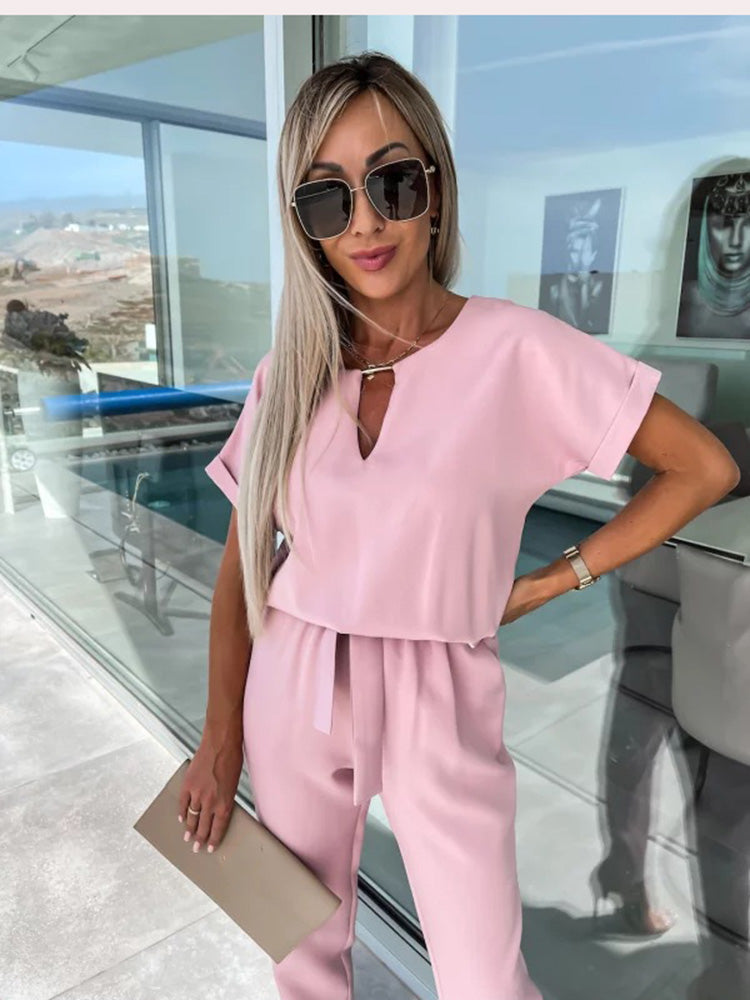 Women's chic wide-leg jumpsuit, belted for a defined waist and comfortable, modern fashion.