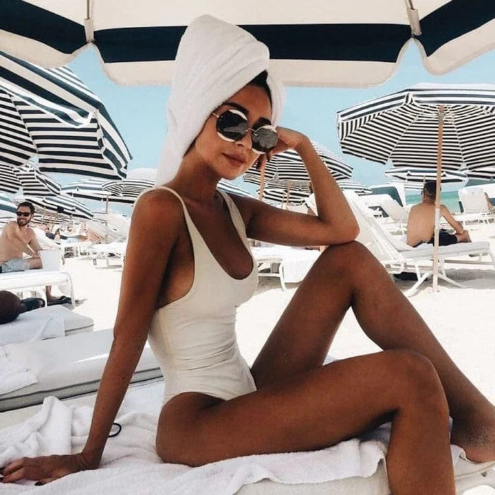 Stylish backless one-piece swimsuit for women. Perfect elegant swimwear for beach, pool, or vacation.