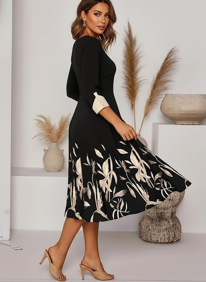 Black floral midi A-line dress with three-quarter sleeves for women. A chic and formal choice for special occasions.